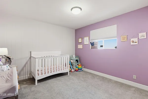 a bathroom with a granite countertop sink a toilet and a mirror