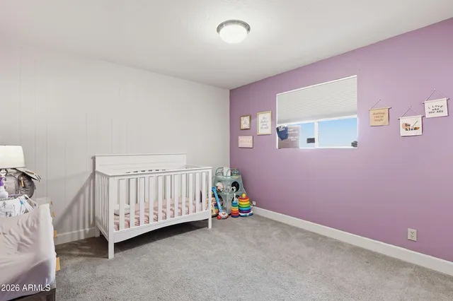 a bathroom with a granite countertop sink a toilet and a mirror