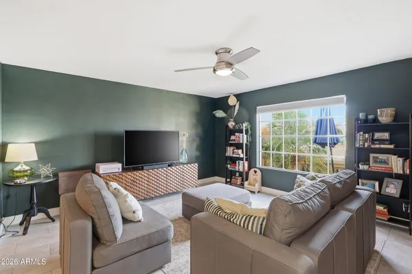 a view of livingroom with workspace and windows