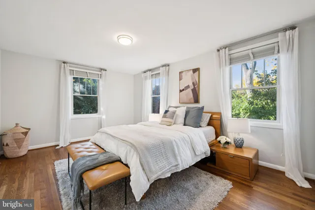 a bedroom with a bed and windows