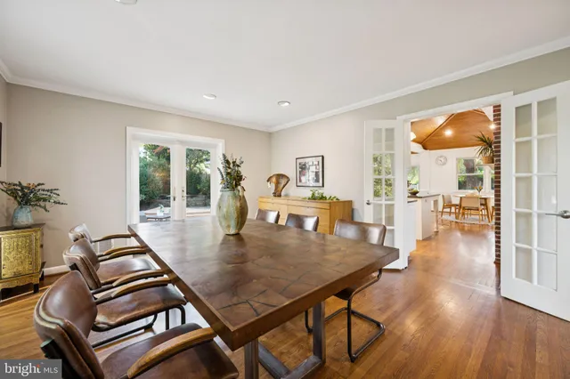 a dining room with furniture and wooden floor
