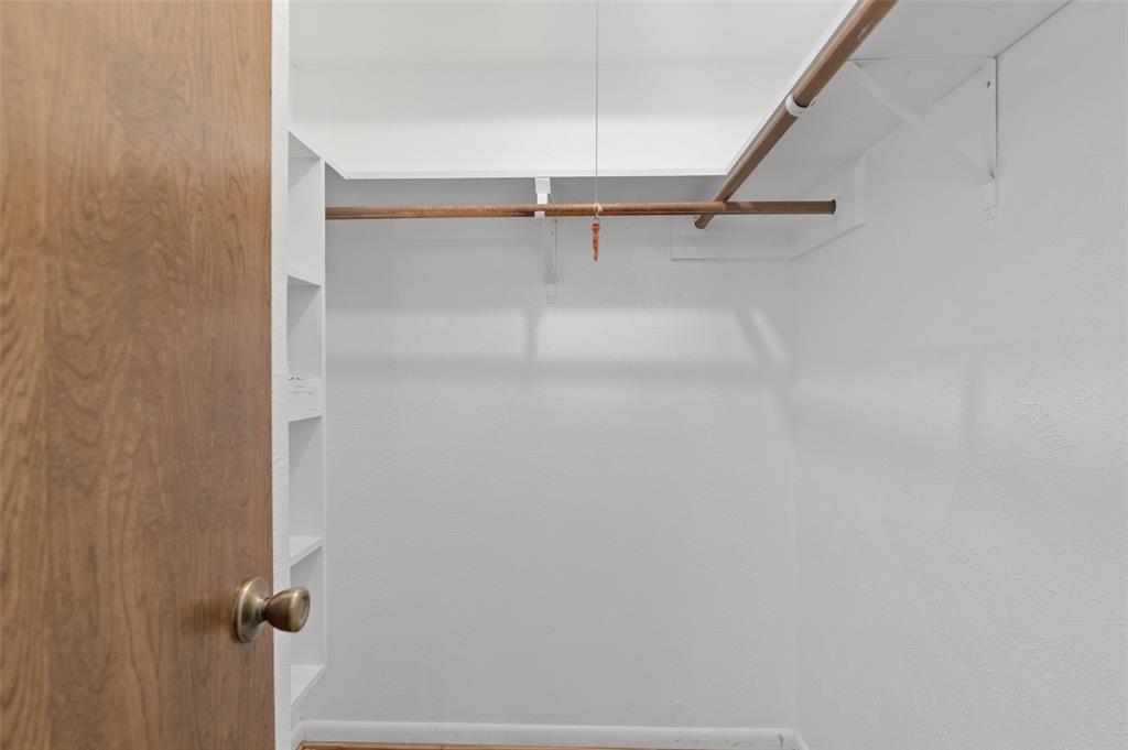 301 East 6th Street Krum, TX 76249 - Photo 11 of 29 Walk-in closet off primary bathroom.
