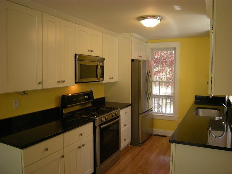 972 River Road Marstons Mills, MA 02648 - Photo 6 of 32 a kitchen with granite countertop a stove and a microwave