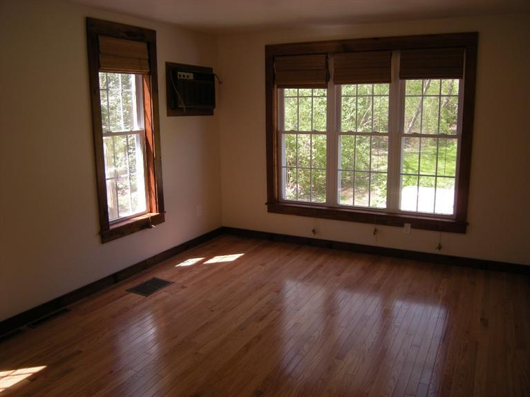 972 River Road Marstons Mills, MA 02648 - Photo 10 of 32 an empty room with wooden floor and windows
