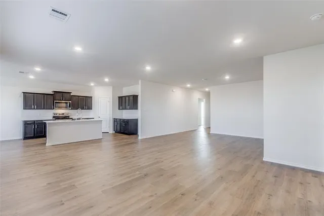 a view of a kitchen with a sink wooden floor and a kitchen counter top space