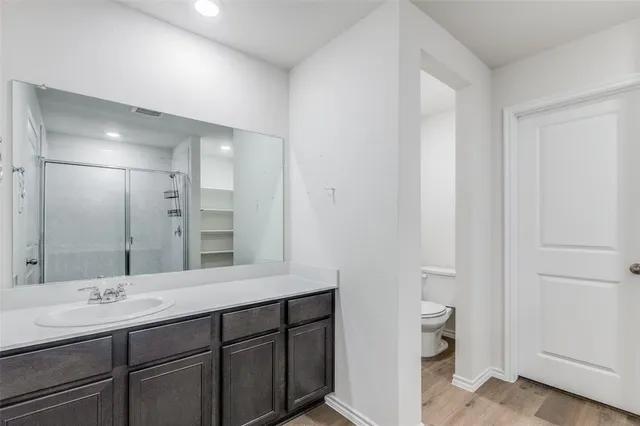 a bathroom with a double vanity sink and mirror
