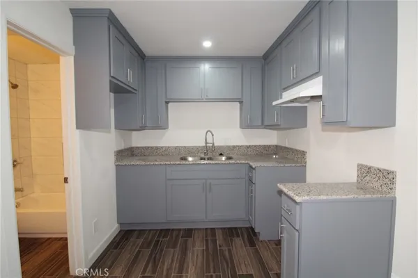 a kitchen with sink and cabinets
