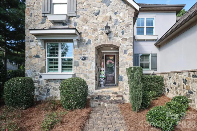 a front view of a house with garden