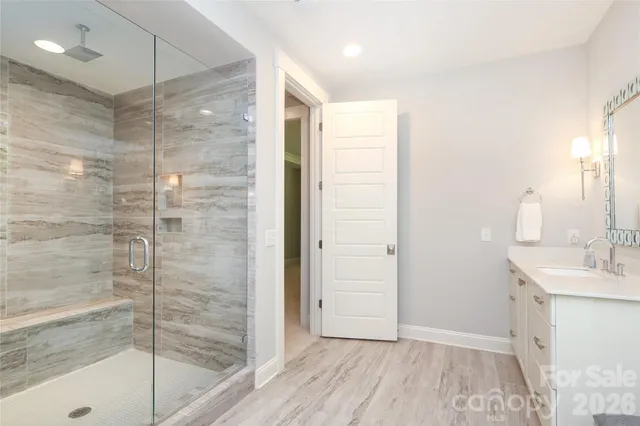 a bathroom with a shower and a sink