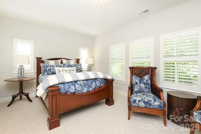 a bedroom with a bed chair and window