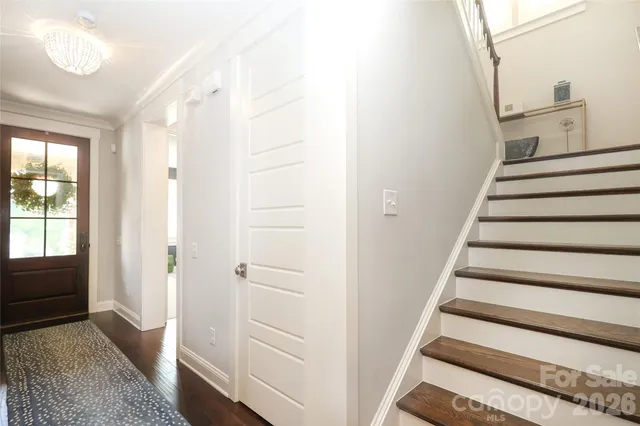 a view of entryway with wooden floor and front door