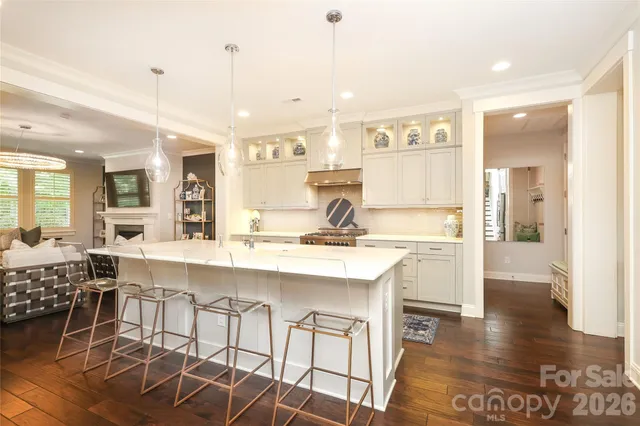a large kitchen with a table and chairs