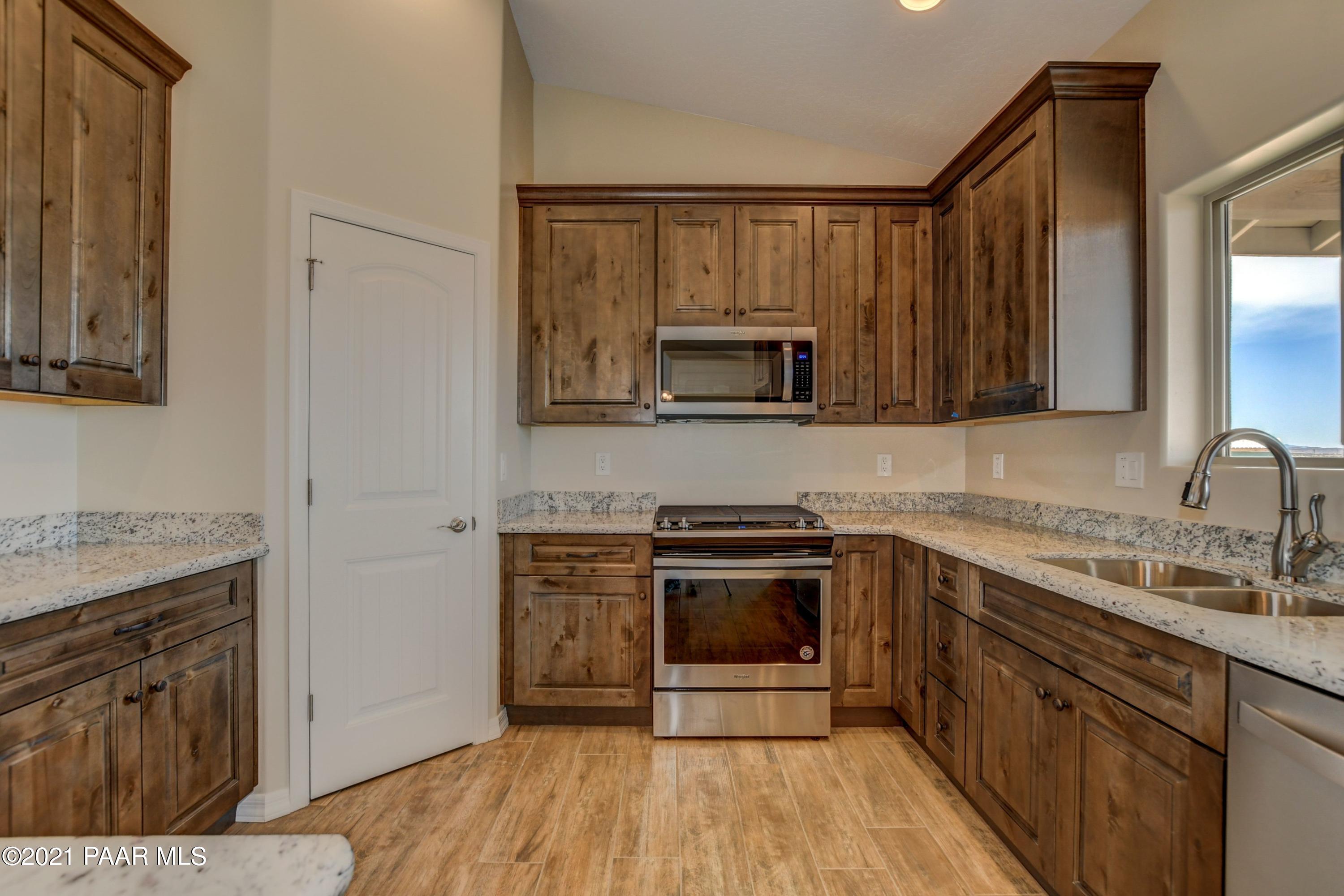 1495 Saddle Road Paulden, AZ 86334 - Photo 16 of 33 a kitchen with a sink stove and microwave