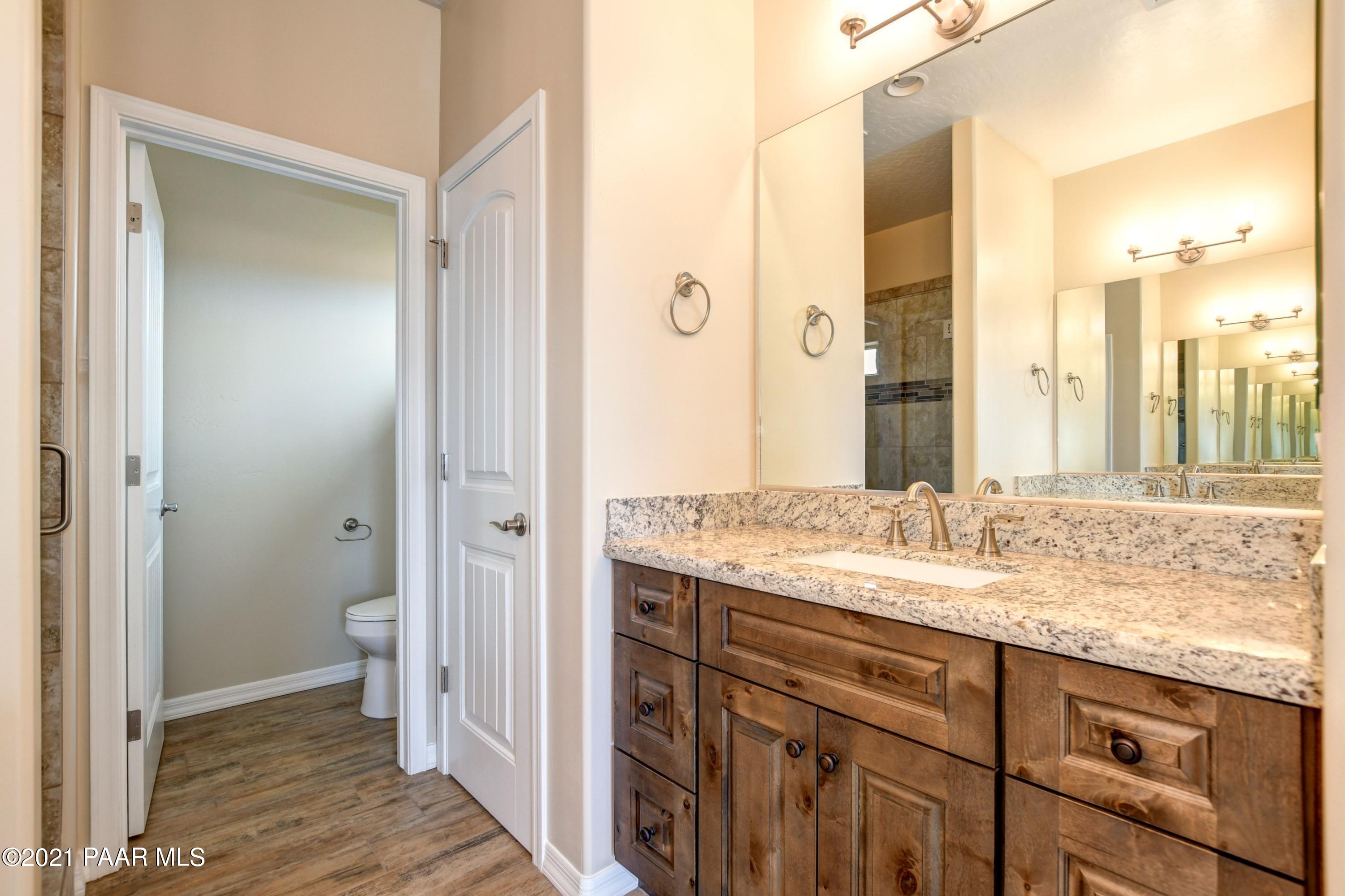 1495 Saddle Road Paulden, AZ 86334 - Photo 19 of 33 a bathroom with a granite countertop sink and a mirror