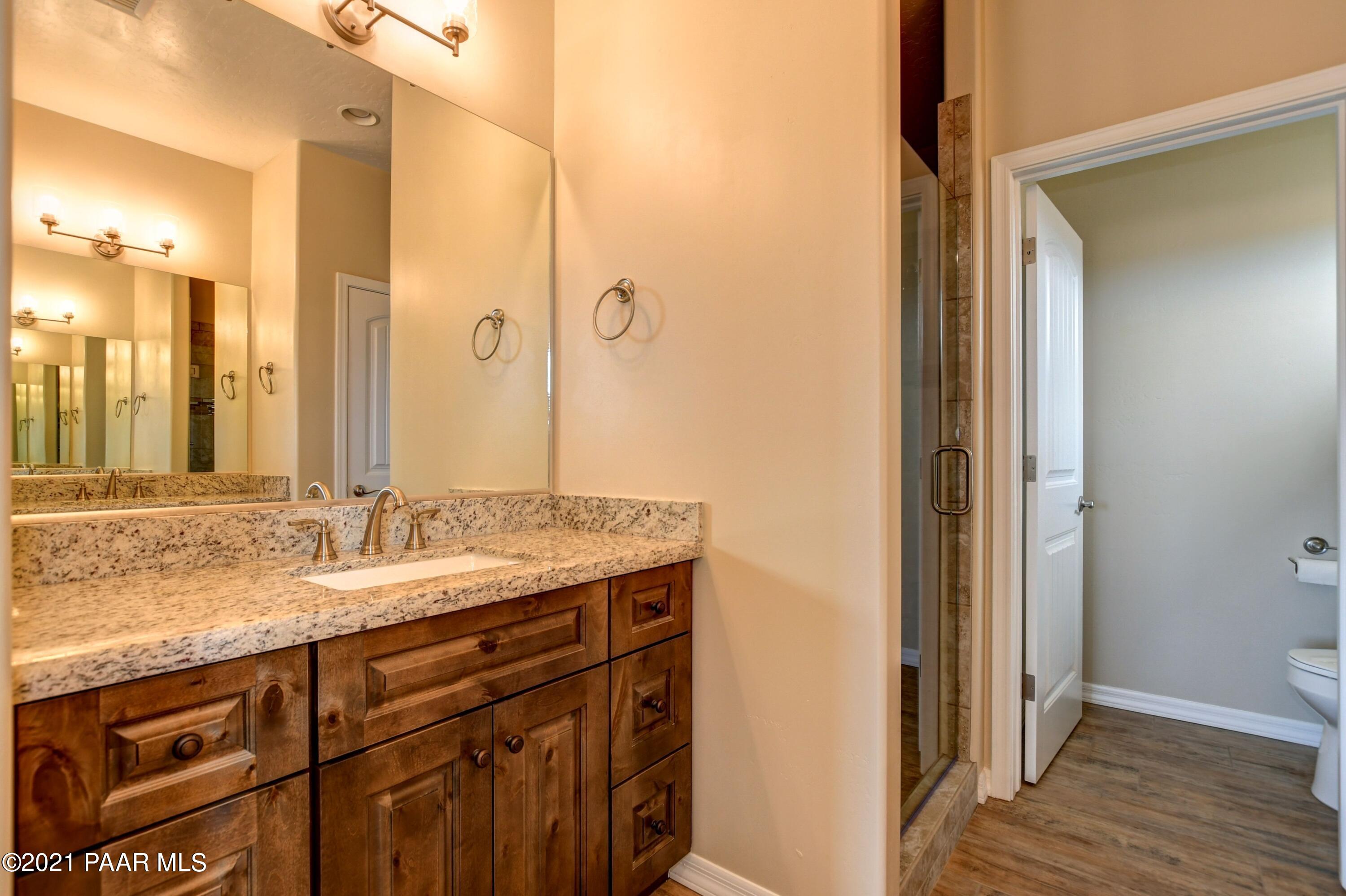 1495 Saddle Road Paulden, AZ 86334 - Photo 27 of 33 a bathroom with a granite countertop sink and a mirror