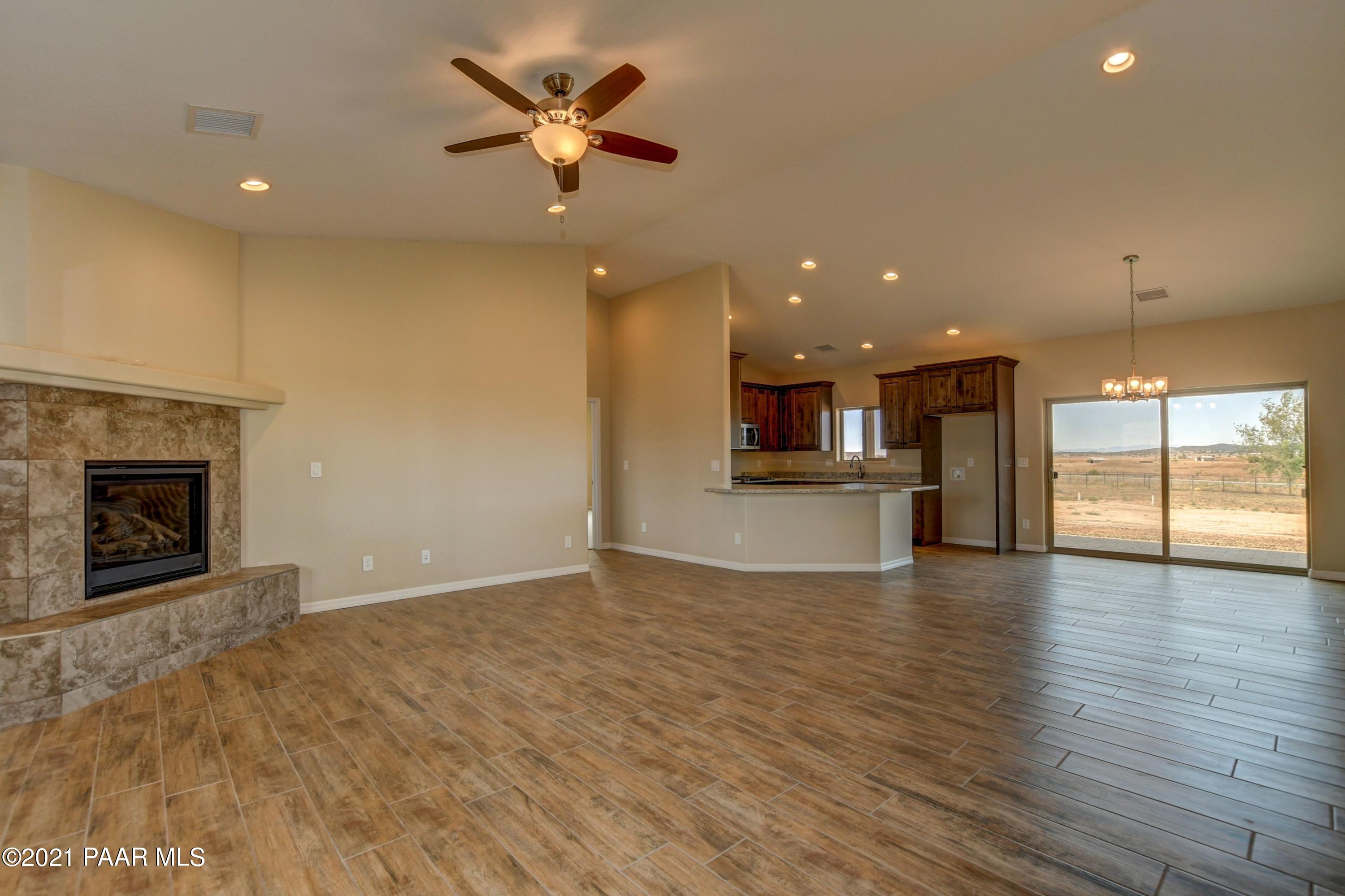 1495 Saddle Road Paulden, AZ 86334 - Photo 6 of 33 a view of empty room with wooden floor and fireplace