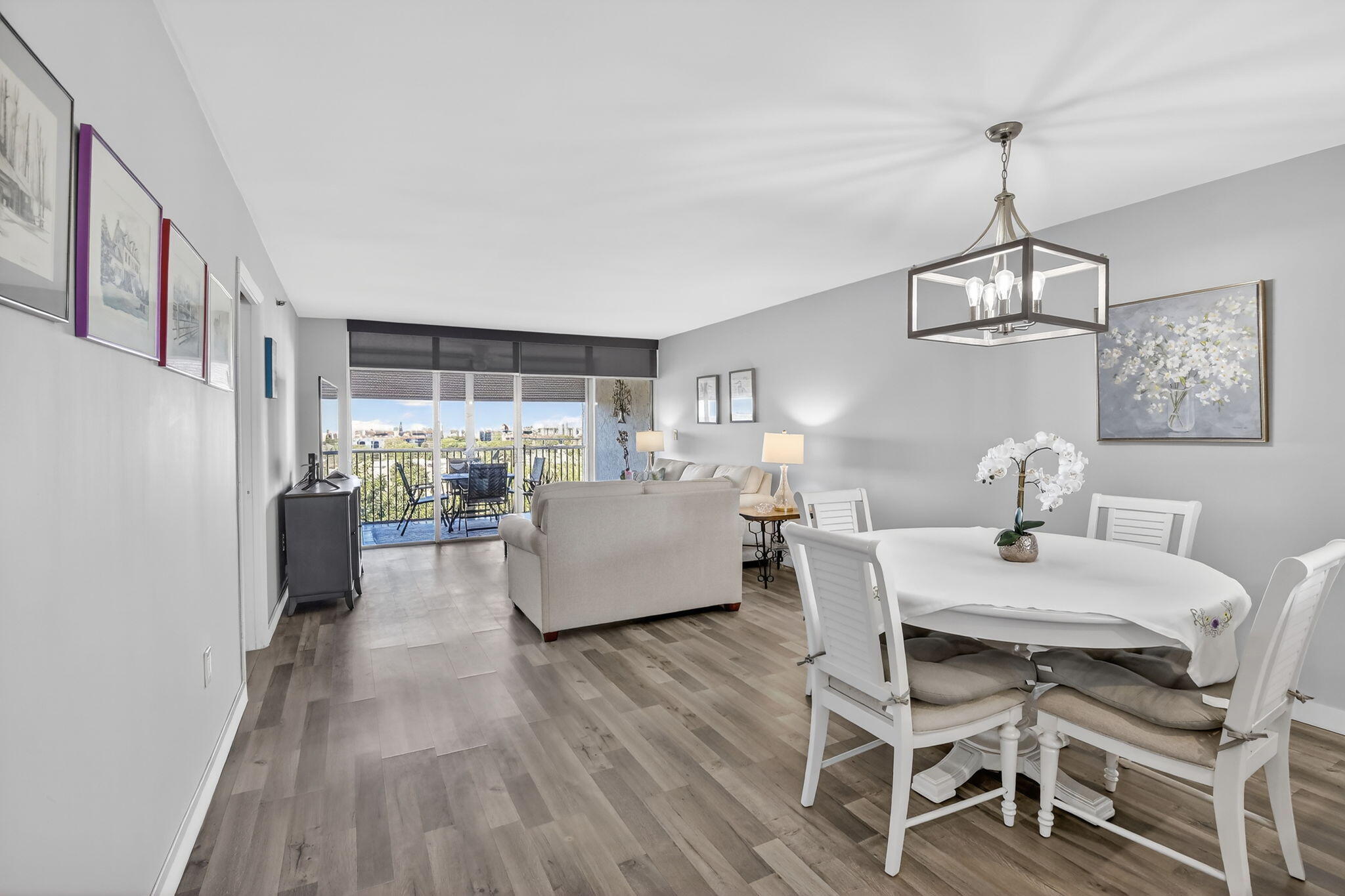 3910 Inverrary Boulevard, Unit 802B Lauderhill, FL 33319 - Photo 11 of 36 a living room with furniture and a wooden floor
