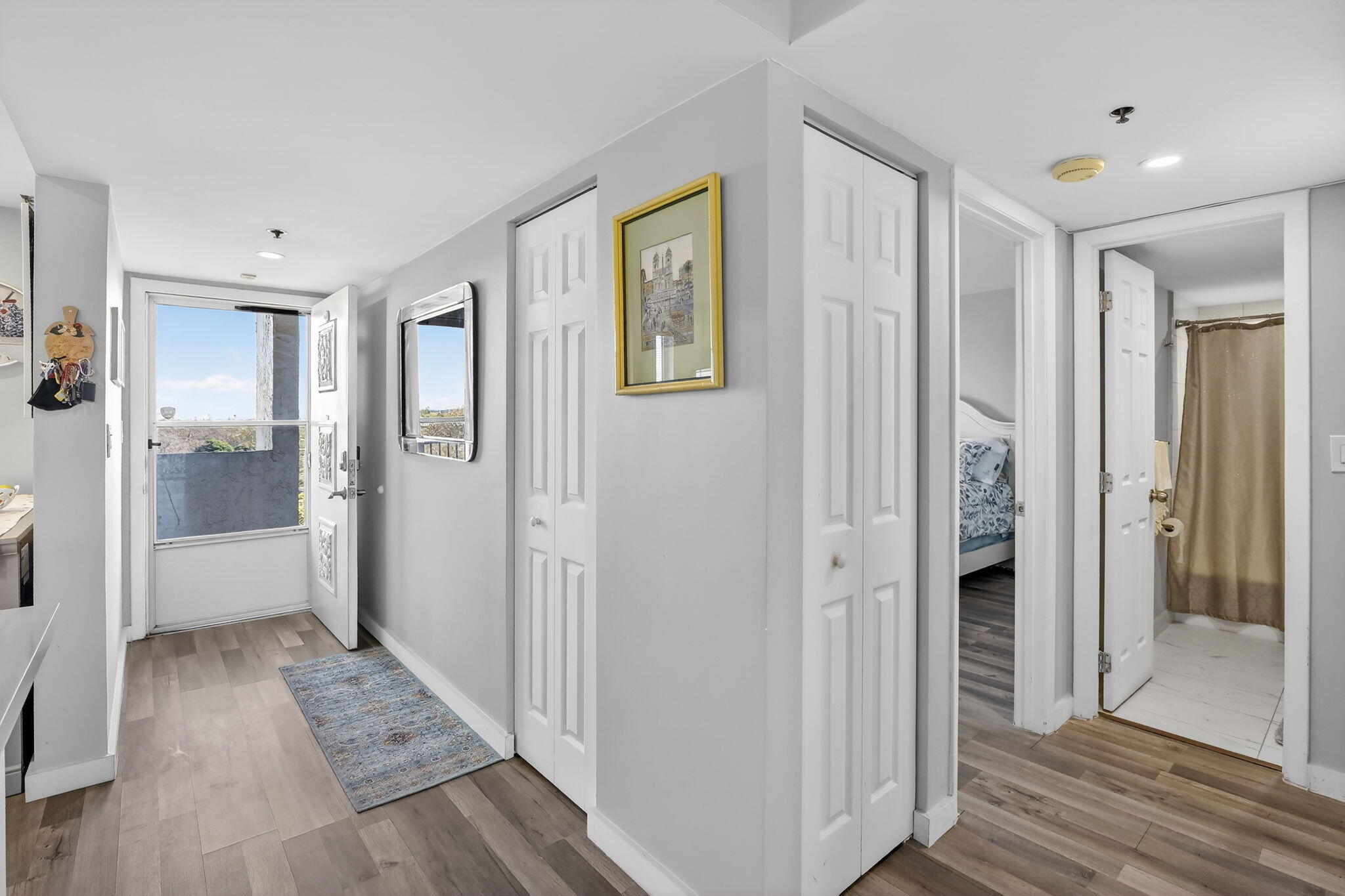 3910 Inverrary Boulevard, Unit 802B Lauderhill, FL 33319 - Photo 15 of 36 a view of a hallway with wooden floor and a bathroom