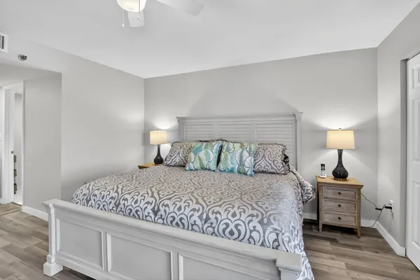 a bedroom with a bed and a lamp