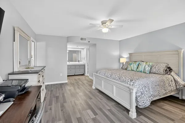 a bedroom with a bed and wooden floor