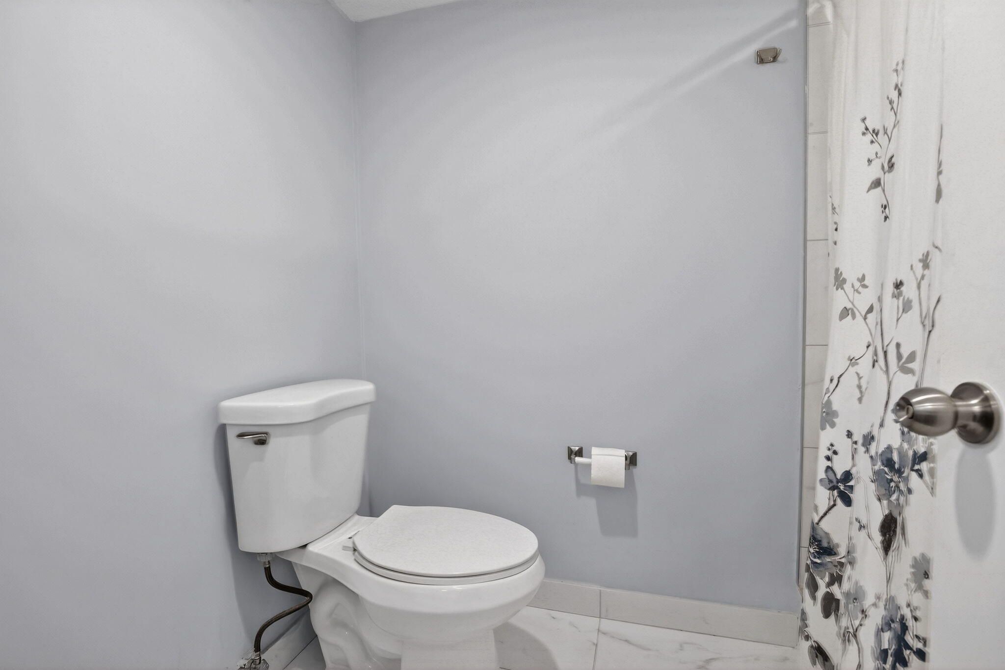 3910 Inverrary Boulevard, Unit 802B Lauderhill, FL 33319 - Photo 21 of 36 a white toilet sitting next to a shower curtain