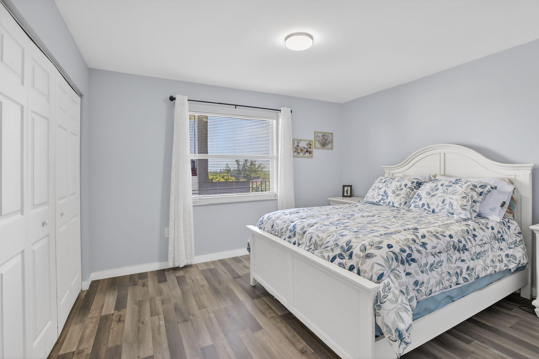 3910 Inverrary Boulevard, Unit 802B Lauderhill, FL 33319 - Photo 22 of 36 a bedroom with a bed and a window