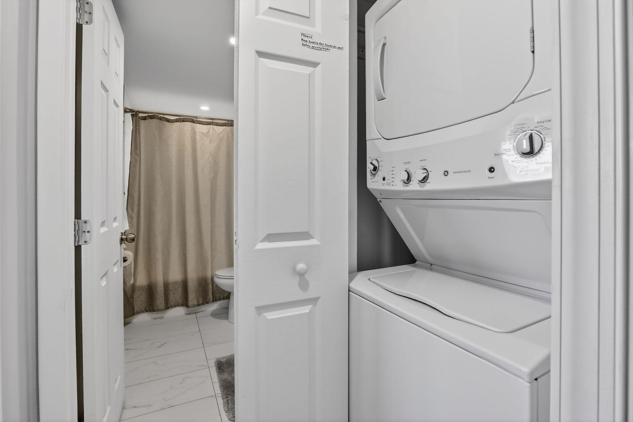 3910 Inverrary Boulevard, Unit 802B Lauderhill, FL 33319 - Photo 25 of 36 a view of washer and dryer with bathroom in the background