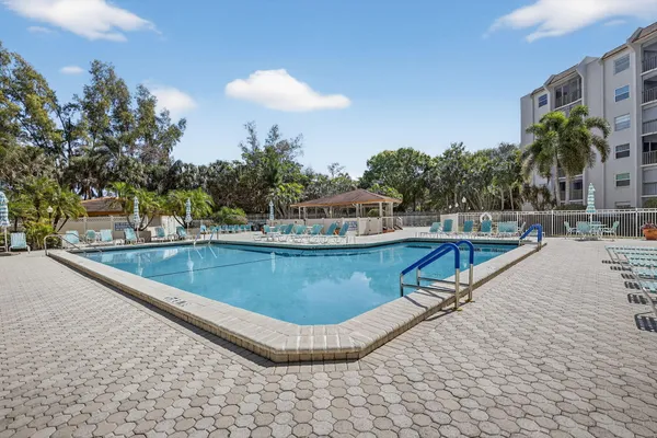 a view of swimming pool with outdoor seating and plants