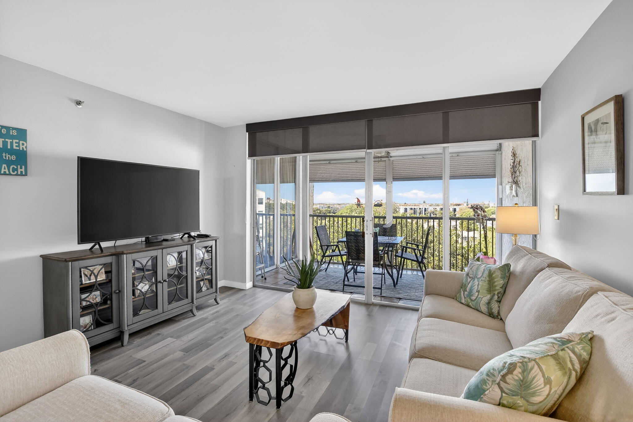 3910 Inverrary Boulevard, Unit 802B Lauderhill, FL 33319 - Photo 3 of 36 a living room with furniture and a flat screen tv