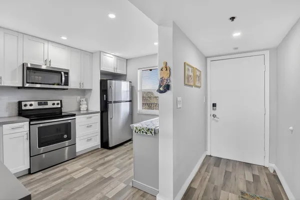 a kitchen with a refrigerator stove and microwave