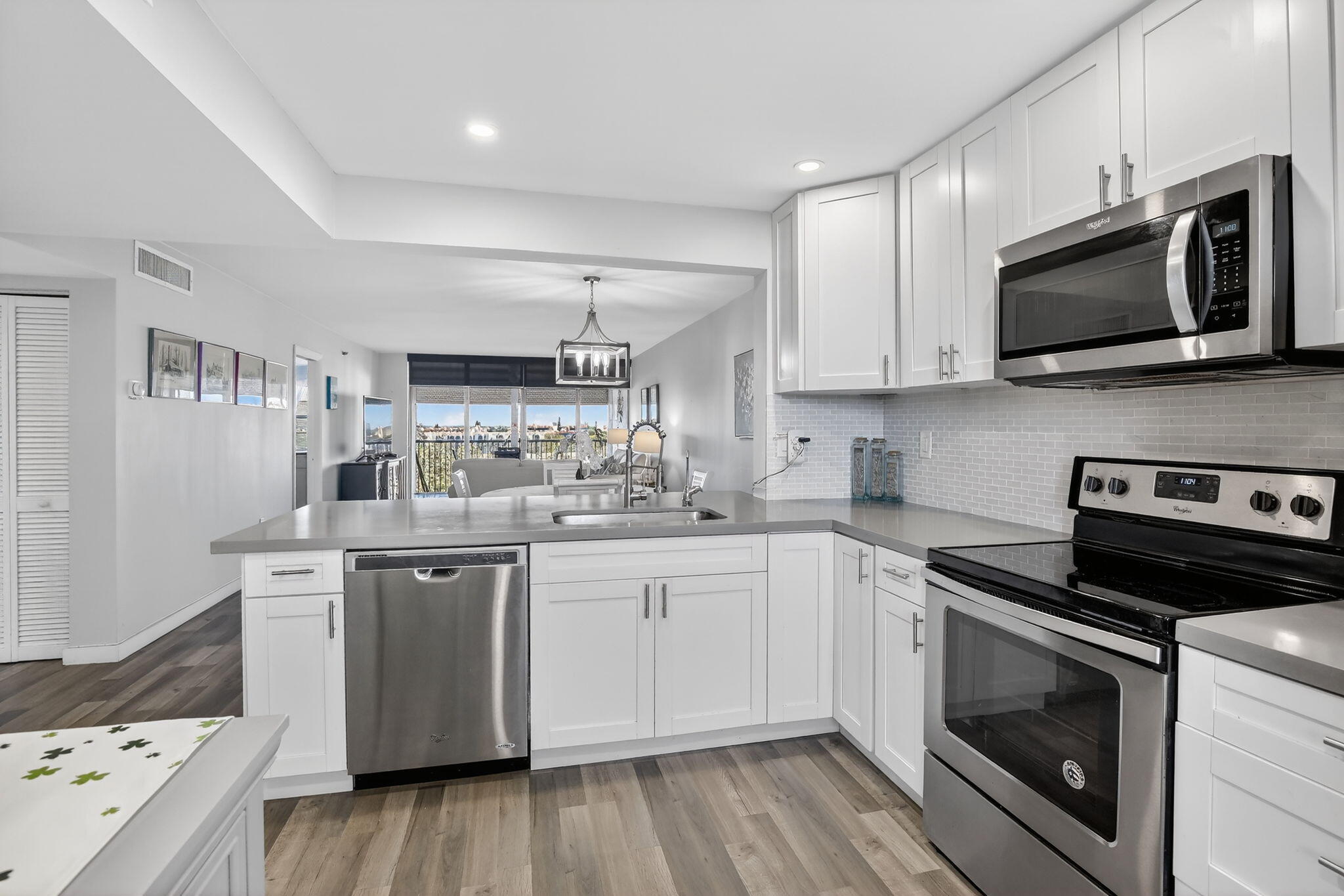 3910 Inverrary Boulevard, Unit 802B Lauderhill, FL 33319 - Photo 7 of 36 a kitchen with stainless steel appliances a stove microwave and sink