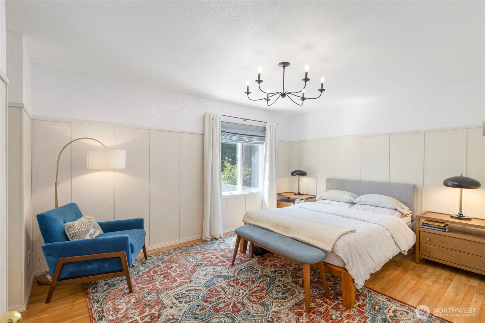 4375 Erin Street Port Townsend, WA 98368 - Photo 15 of 40 a bedroom with a bed and a chandelier