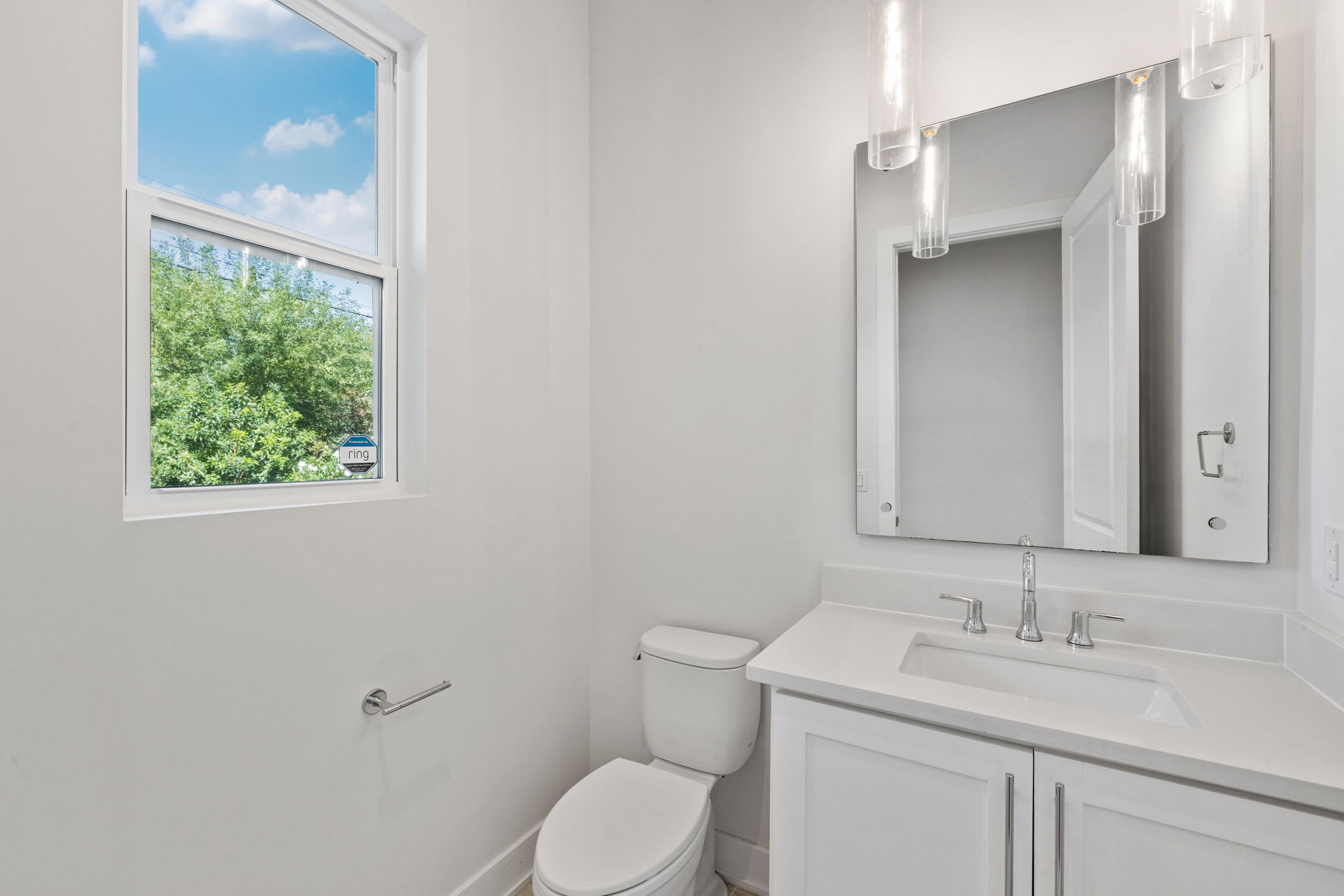 1719 Bunche Road Austin, TX 78721 - Photo 15 of 36 Natural light fills this modern powder room through a large window above the vanity.