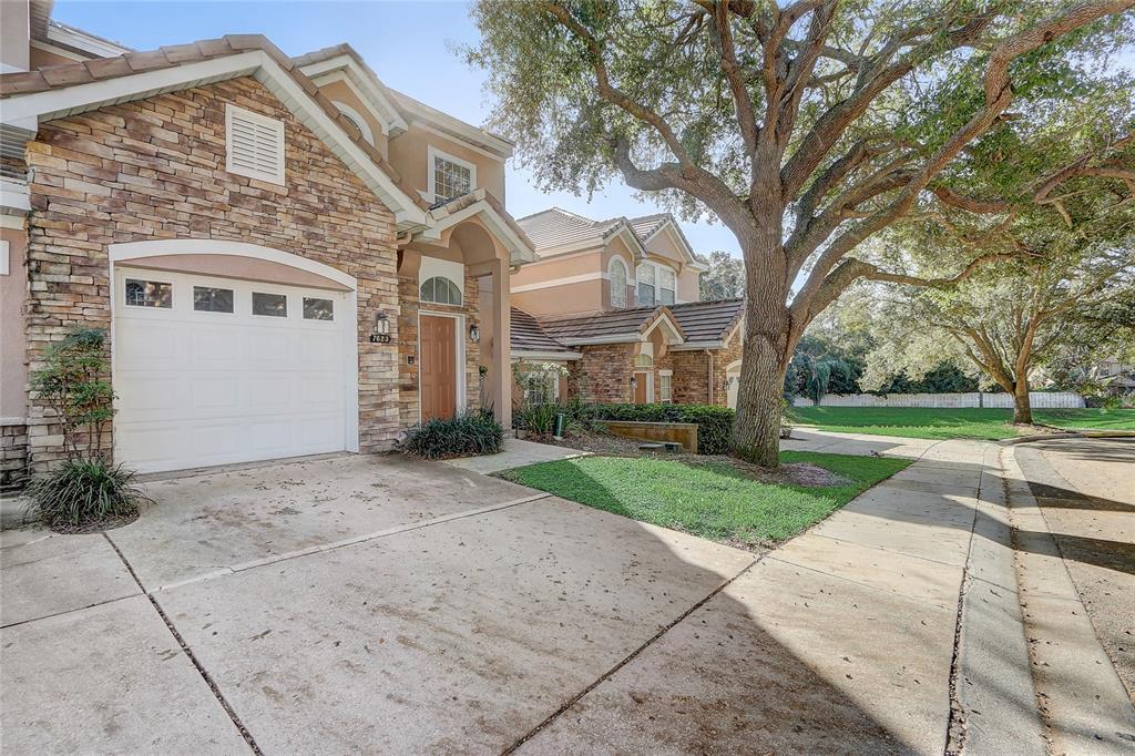 7623 Bayport Road, Unit 60 Orlando, FL 32819 - Photo 1 of 1 a front view of a house with a yard