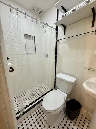 a bathroom with a toilet and shower