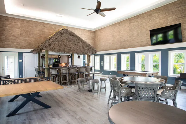 a view of a swimming pool with a patio and a yard