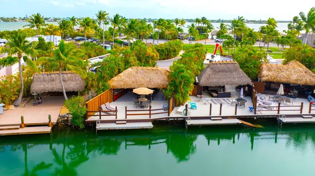 a view of a house with pool and chairs