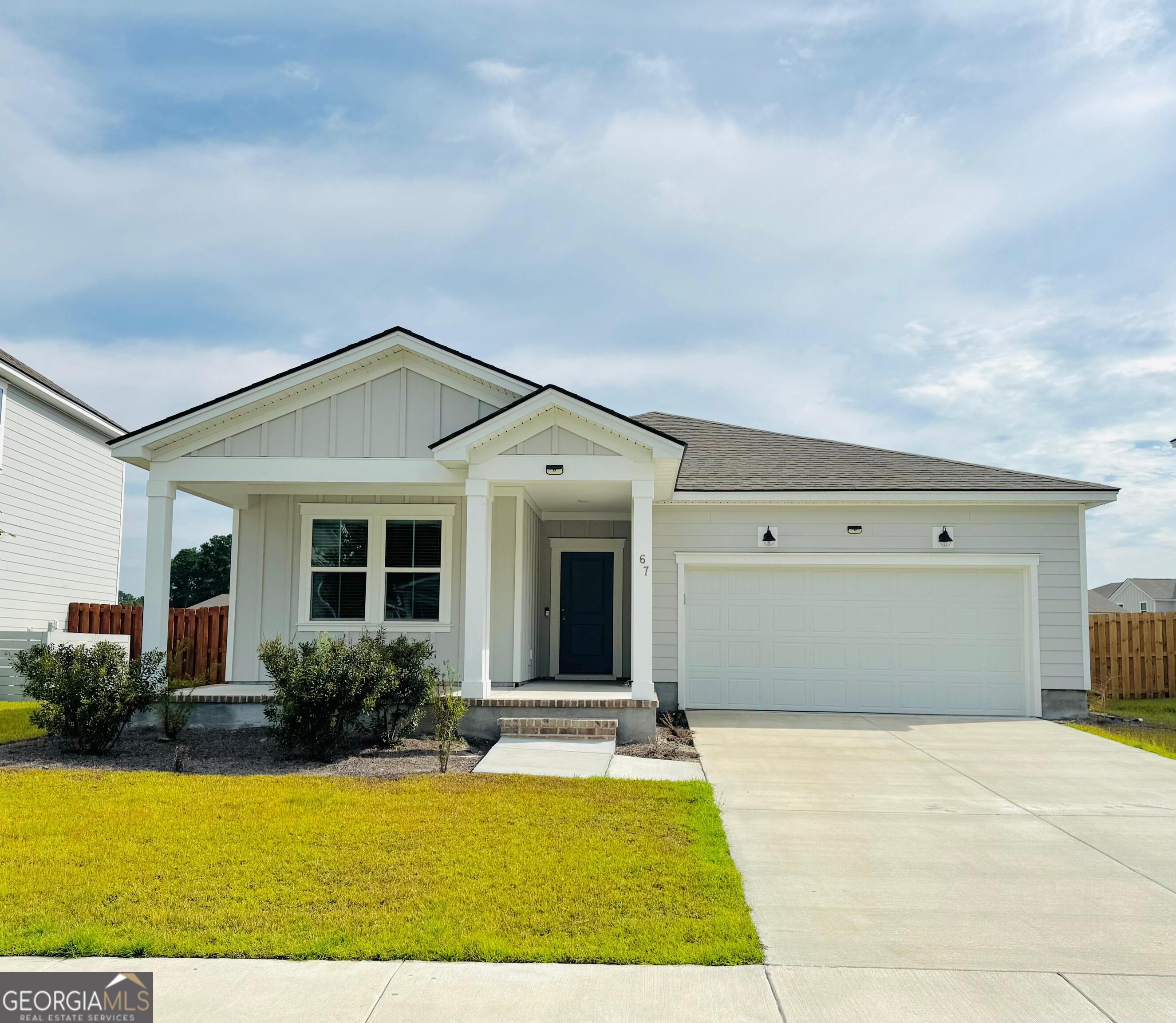 67 Shade Tree Drive Richmond Hill, GA 31324 - Photo 1 of 25 a front view of a house with yard