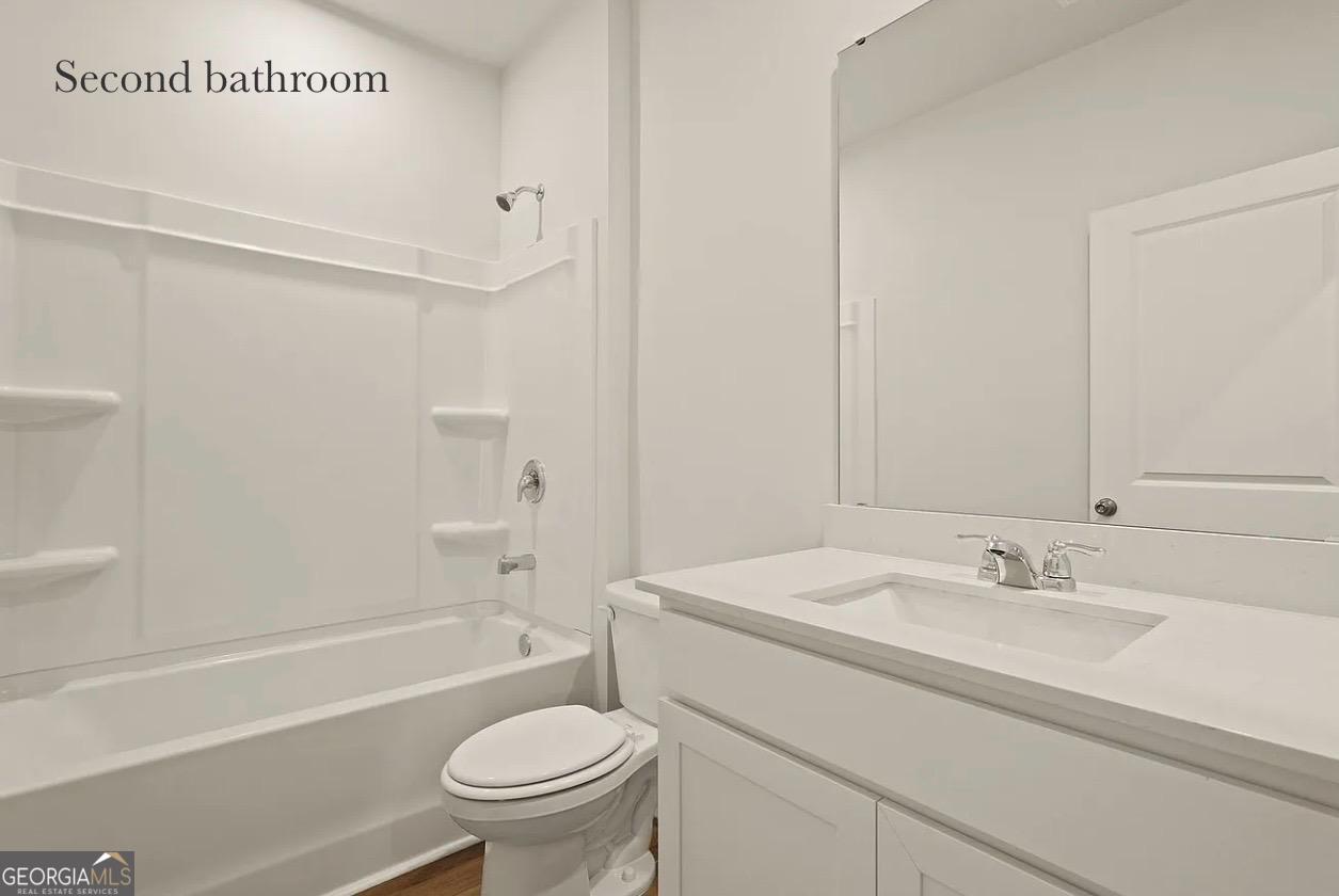 67 Shade Tree Drive Richmond Hill, GA 31324 - Photo 20 of 25 a bathroom with a sink a toilet and a bathtub