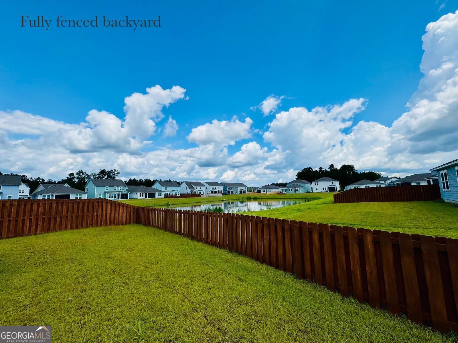 67 Shade Tree Drive Richmond Hill, GA 31324 - Photo 23 of 25 a view of a garden with wooden fence