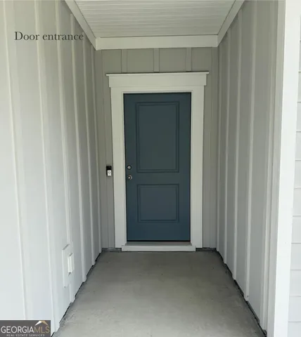 a view of a hallway with wooden door