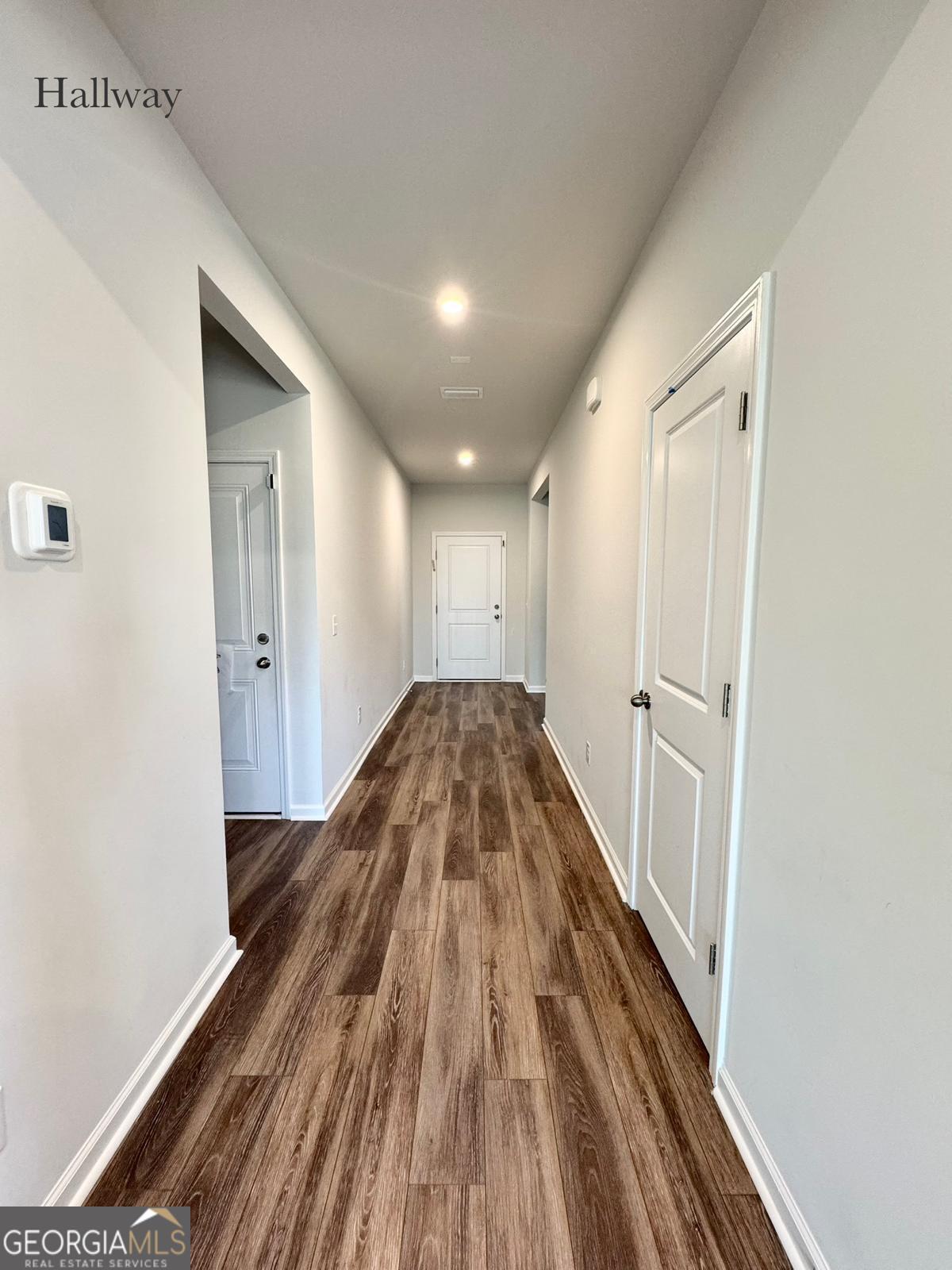 67 Shade Tree Drive Richmond Hill, GA 31324 - Photo 4 of 25 a view of a hallway with wooden floor