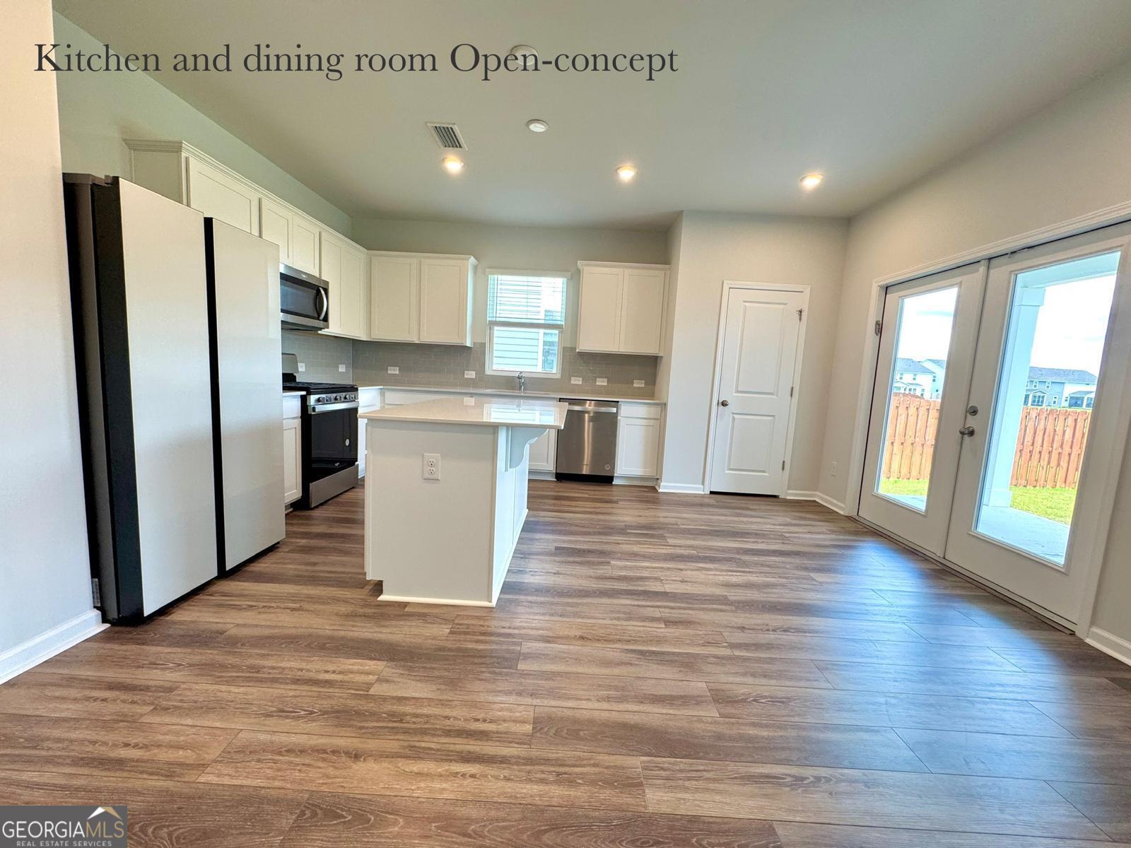 67 Shade Tree Drive Richmond Hill, GA 31324 - Photo 7 of 25 a kitchen with stainless steel appliances granite countertop a refrigerator and a sink