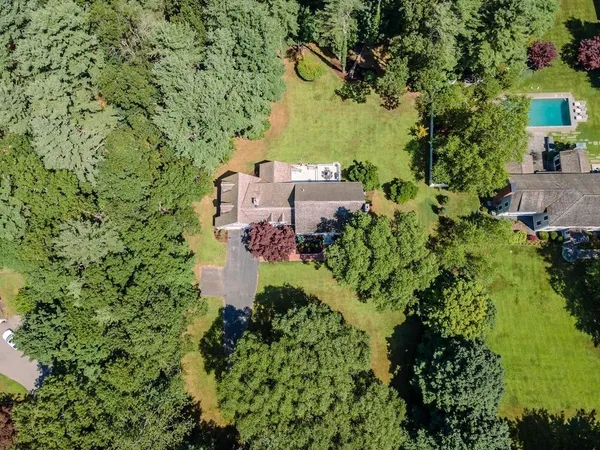 an aerial view of a house with a yard