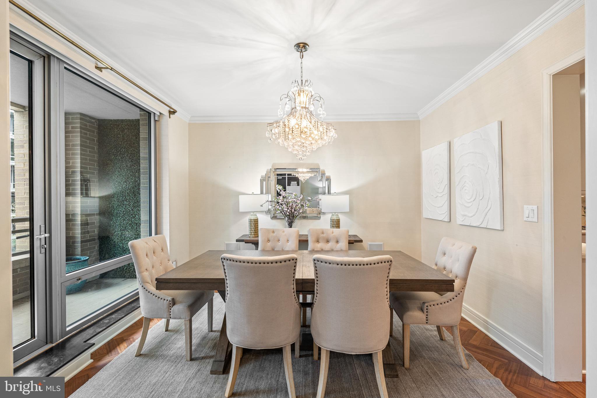 1111 23rd Street Northwest, Unit 4C Washington, DC 20037 - Photo 17 of 45 a dining room with furniture a chandelier and wooden floor