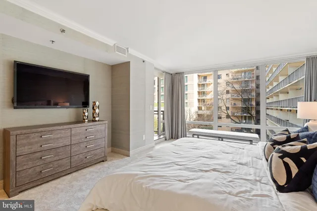 a bedroom with a bed and a large window