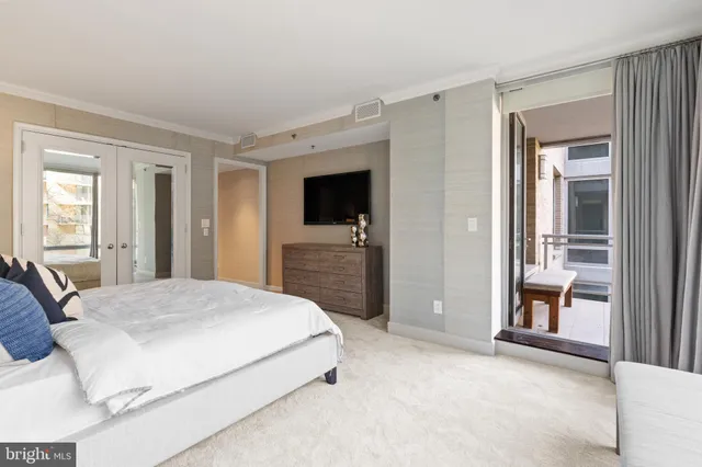 a bedroom with a large bed and furniture