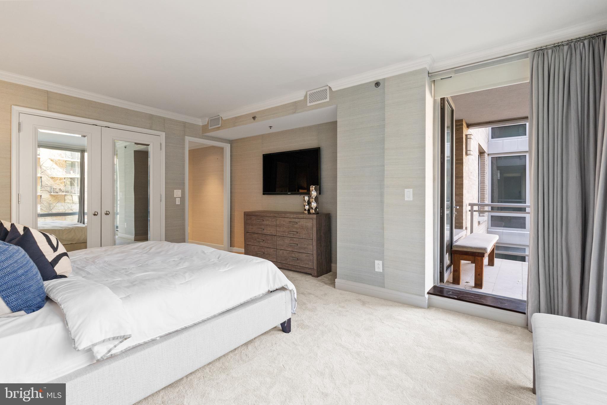 1111 23rd Street Northwest, Unit 4C Washington, DC 20037 - Photo 25 of 45 a bedroom with a bed and a television