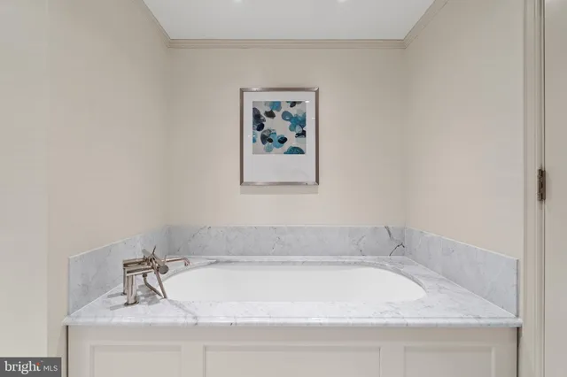 a white bath tub sitting next to a shower