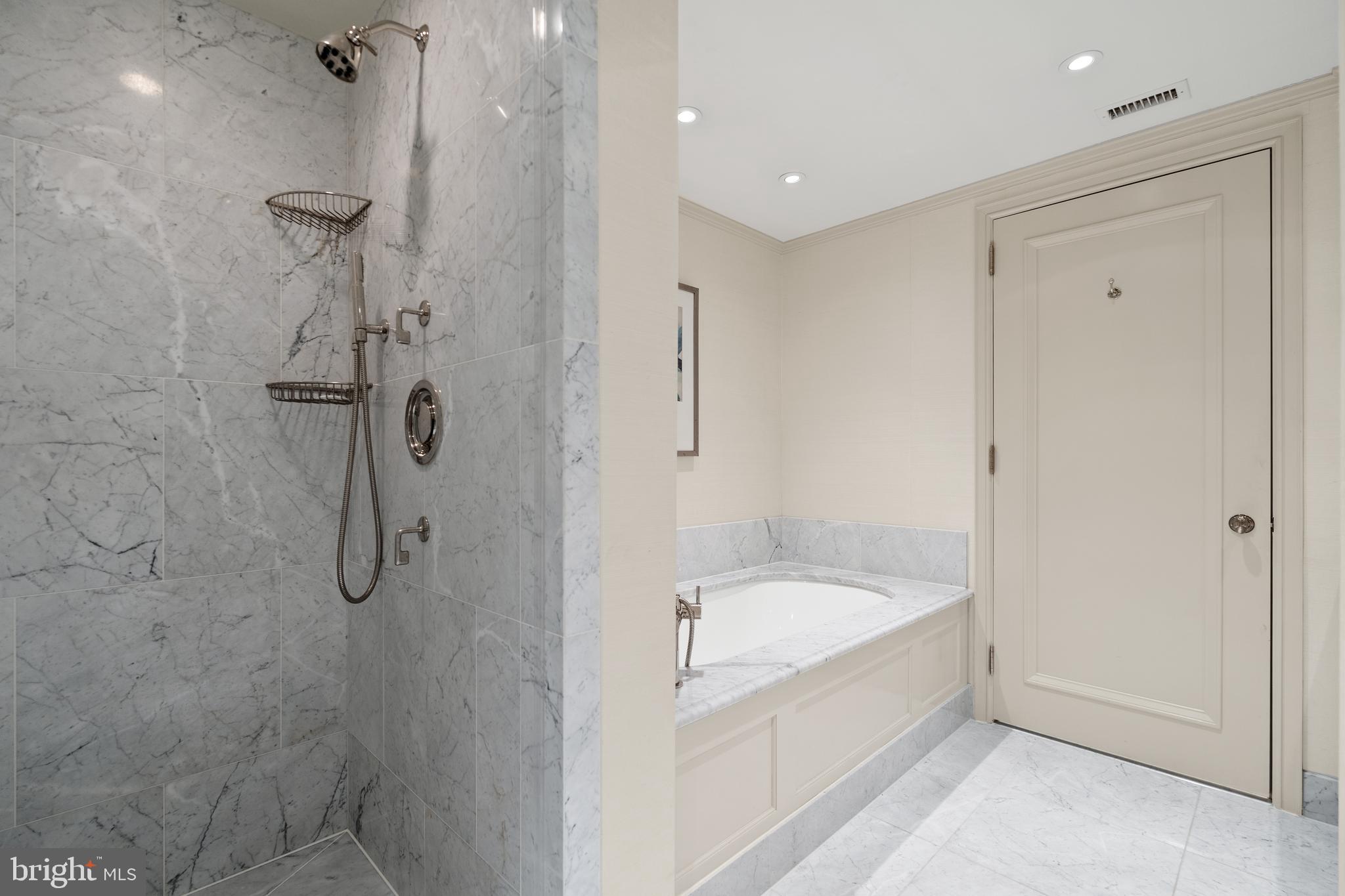 1111 23rd Street Northwest, Unit 4C Washington, DC 20037 - Photo 33 of 45 a white bath tub sitting next to a shower